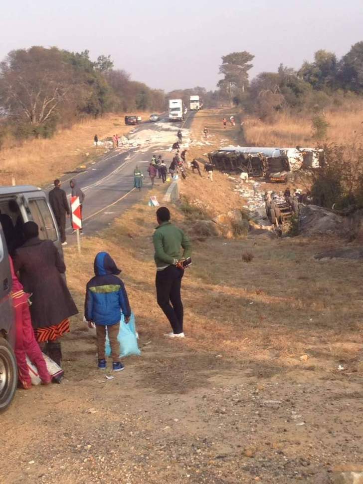 People collected free rice after a rice truck and oil tanker collided