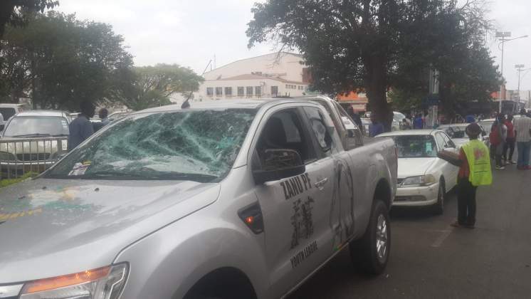 ZANU PFvehicle stoned while parked on Leopold Takawira street. #ShutdownZimbabwenow!#