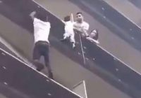 AFRICAN IMMIGRANT, FILMED SCALING FOUR FLOORS IN A FEW SECONDS IN A Paris building to save a four-year-old dangling from a balcony.