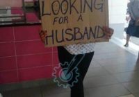 A Gweru woman moves around waving a placard   looking for a husband.